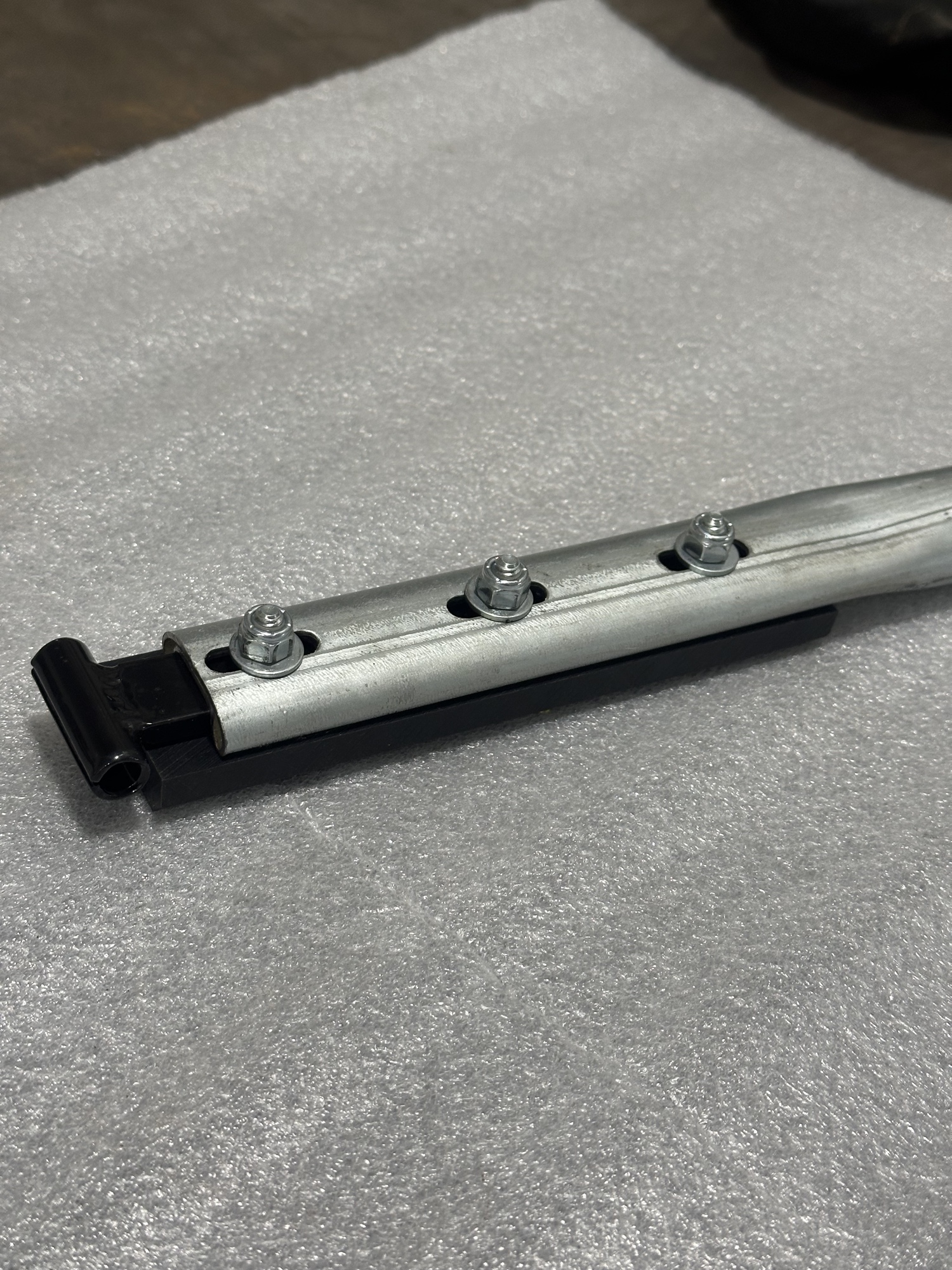 Galvanized adjustable bow — die-stamped, precision-formed, with integrated UHMW top rail slider.