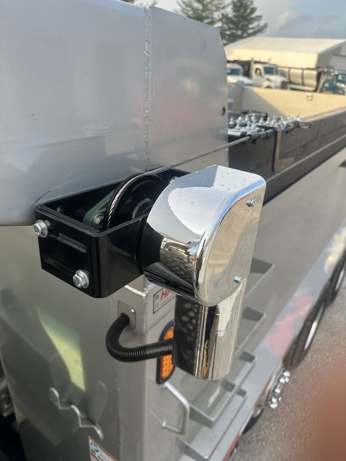 Close-up of the Buffalo Tarp direct-drive head assembly with electric motor and switch, mounted on a truck.