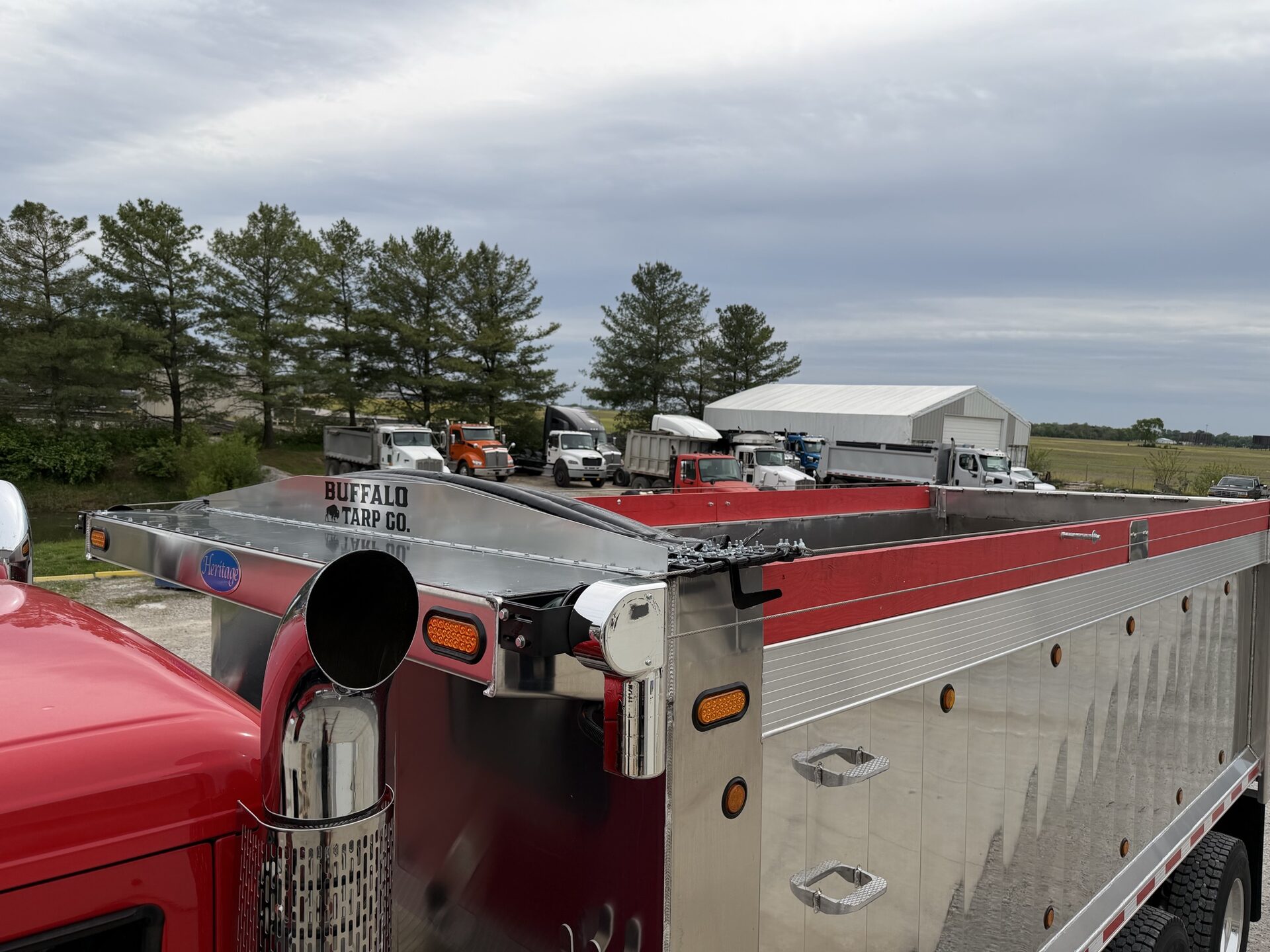 Buffalo Tarp Co. branded head assembly on a red Peterbilt dump truck